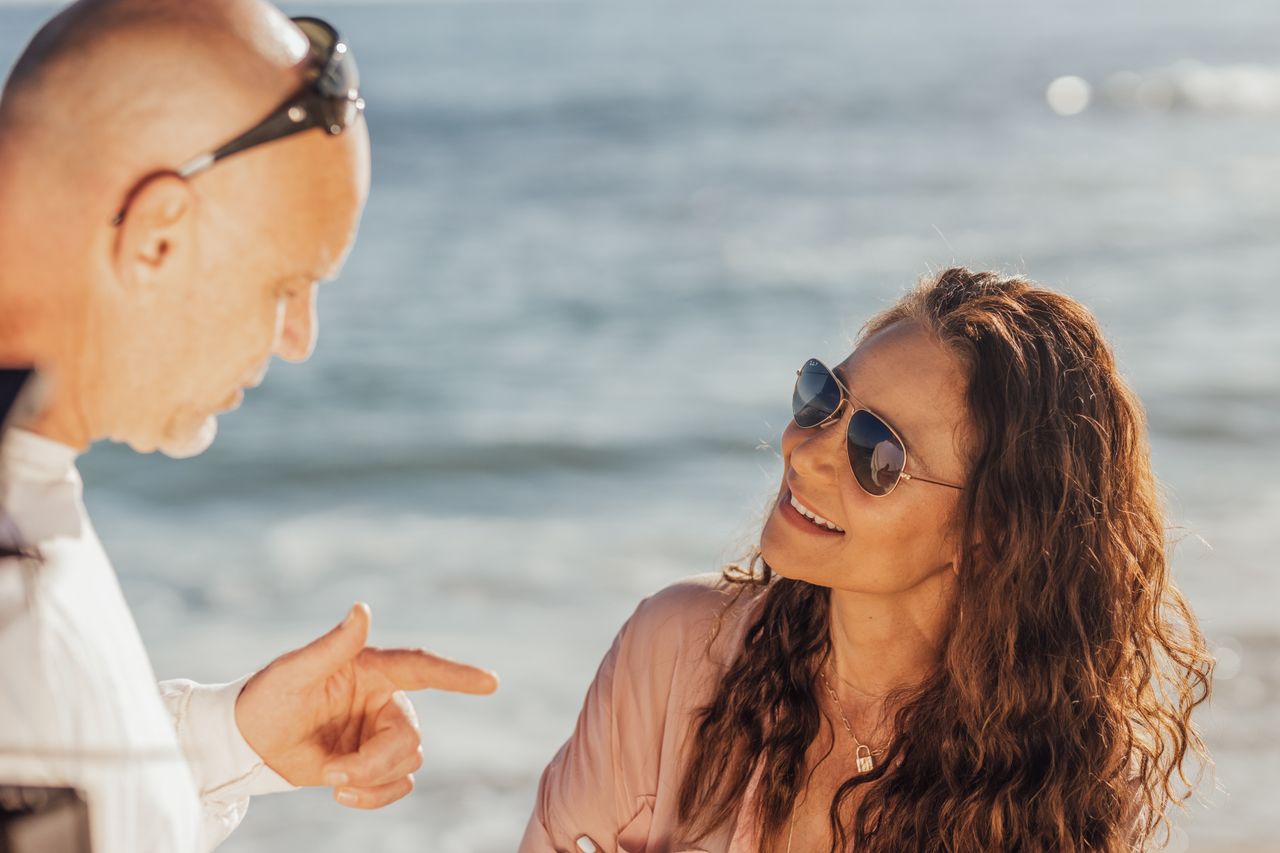 Man and women having a conversation on the beach