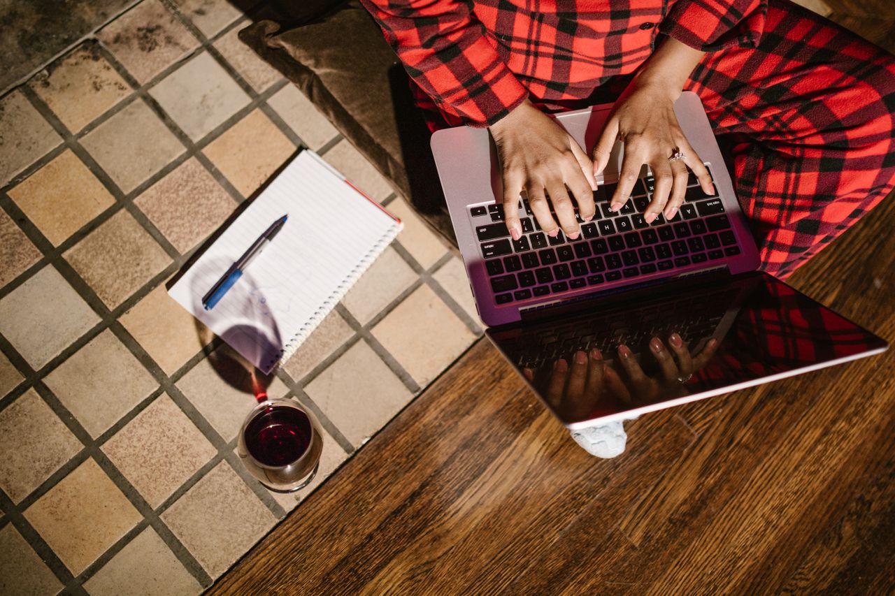 Person typing a story on a laptop at night